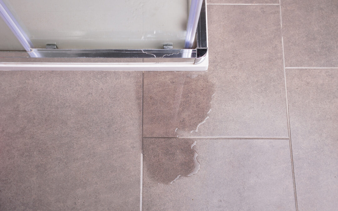 Leakage of water from a shower cabin with glass wall that is damaged