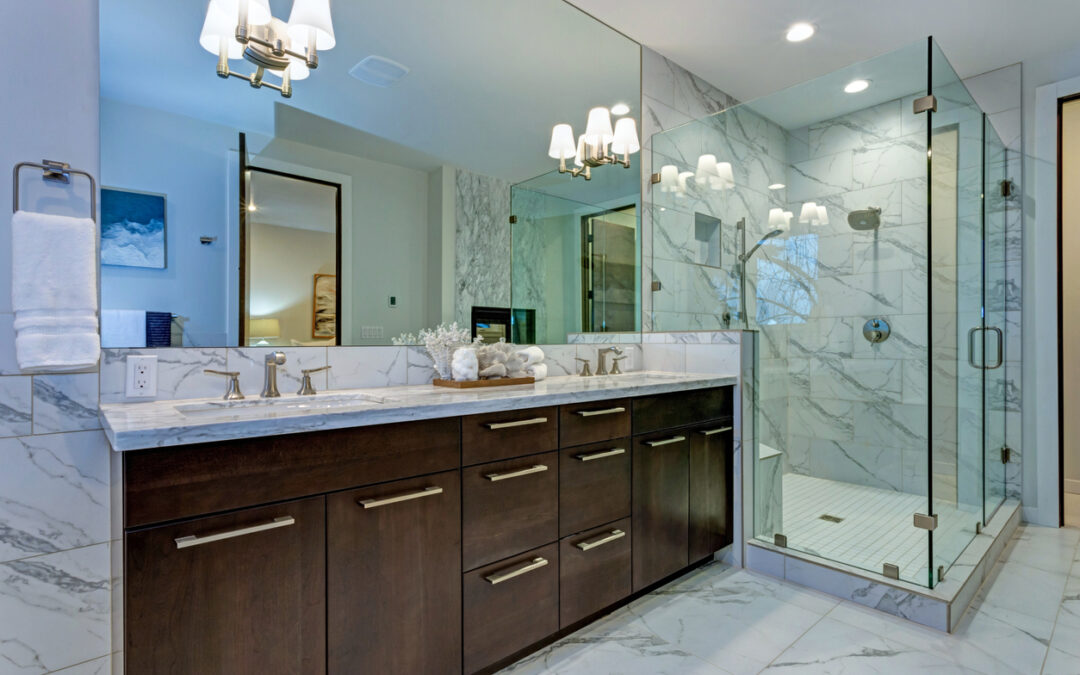 Incredible master bathroom with Carrara marble tile surround, modern glass walk in shower, espresso dual vanity cabinet and a freestanding bathtub.